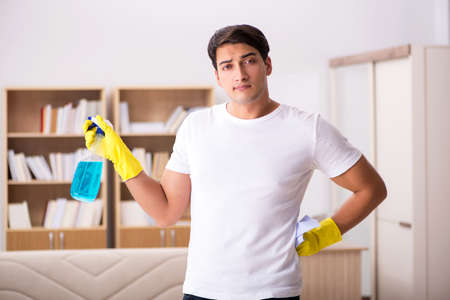 Man husband cleaning the house helping wifeの写真素材