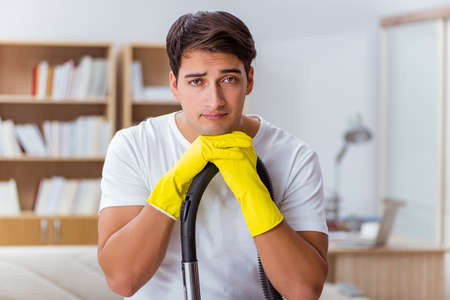 Man husband cleaning the house helping wifeの写真素材