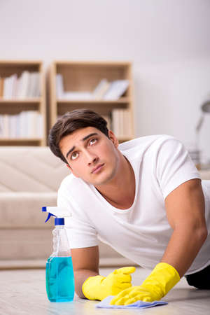 Man husband cleaning the house helping wifeの写真素材