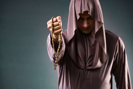 Monk in religious concept on gray backgroundの写真素材