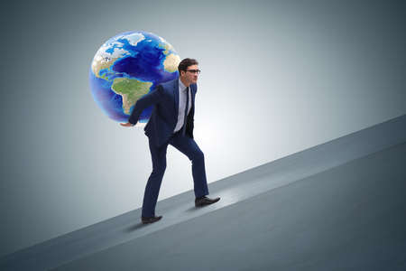 Businessman carrying Earth on his shouldersの写真素材