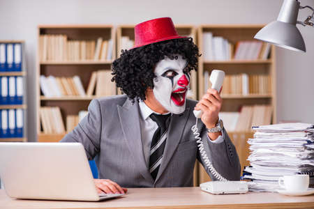 Clown businessman working in the officeの写真素材