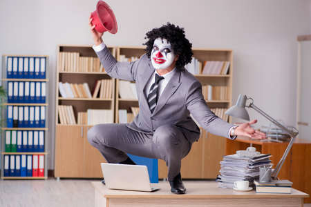 Clown businessman working in the officeの写真素材