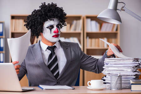 Clown businessman working in the officeの写真素材