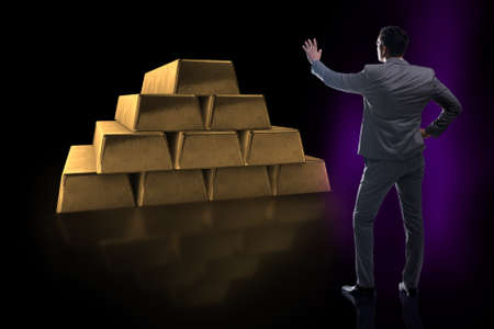 Businessman walking towards gold barsの写真素材