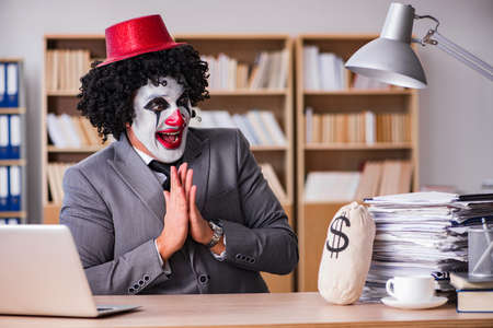 Clown businessman working in the officeの写真素材