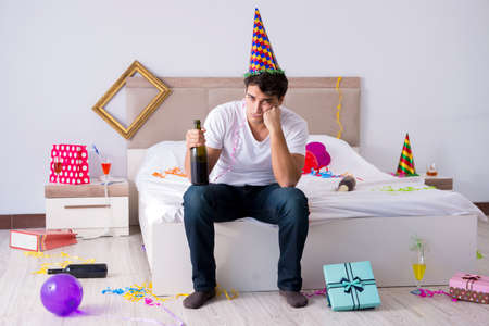 Man at home after heavy partyingの写真素材