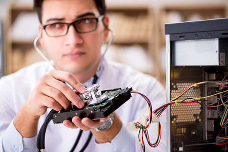 Proffesional repairman repairing broken hard driveの写真素材