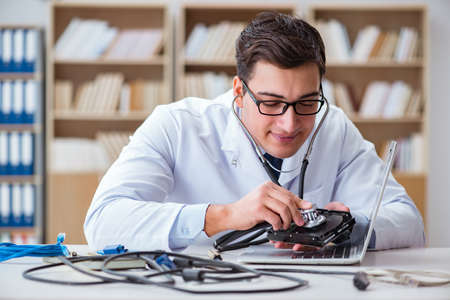 Proffesional repairman repairing broken hard driveの写真素材