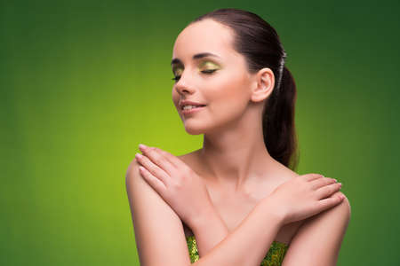 Young woman in beauty concept on green backgroundの写真素材