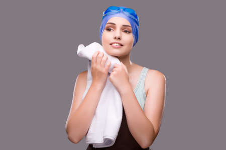 Woman swimmer against grey backgroundの写真素材