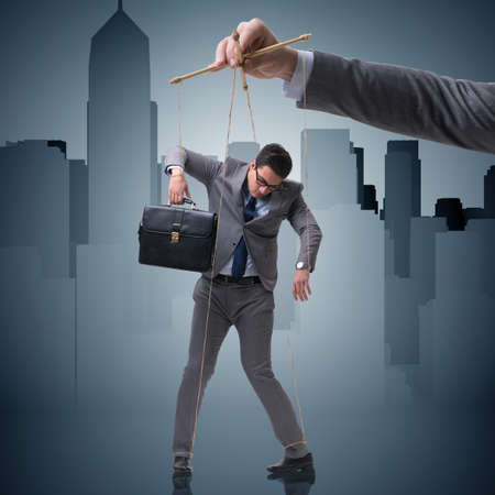 Businessman puppet being manipulated by bossの写真素材