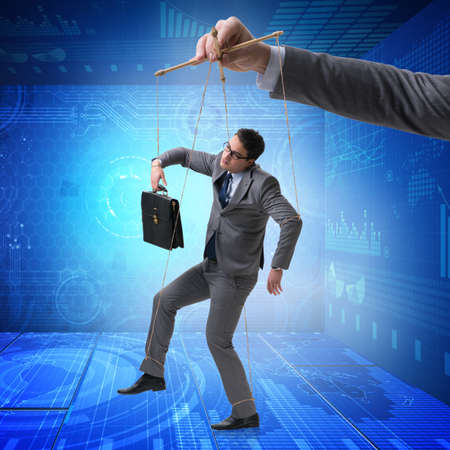 Businessman puppet being manipulated by bossの写真素材