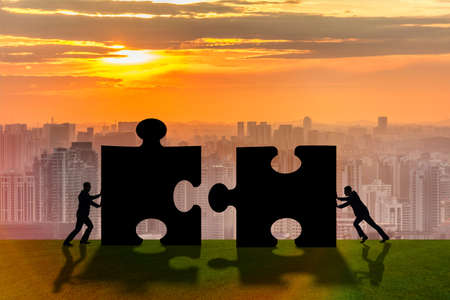 Business metaphor of teamwork with jigsaw puzzleの写真素材