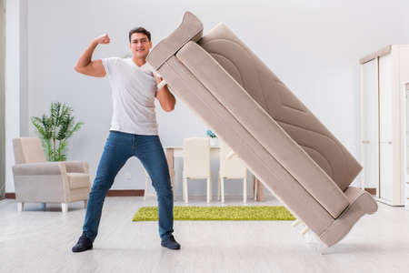Man moving furniture at homeの写真素材