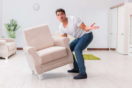 Man moving furniture at homeの写真素材