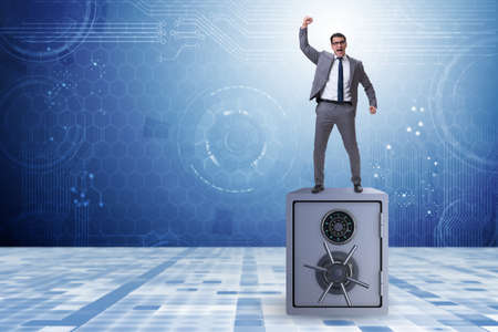 Excited businessman standing on top of safeの写真素材