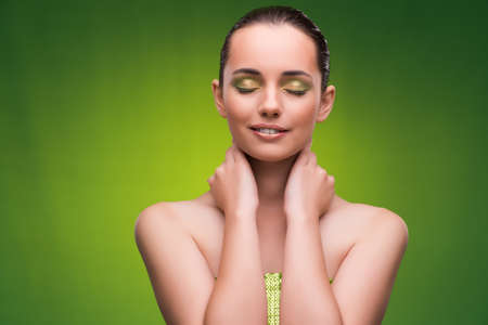 Young woman in beauty concept on green backgroundの写真素材