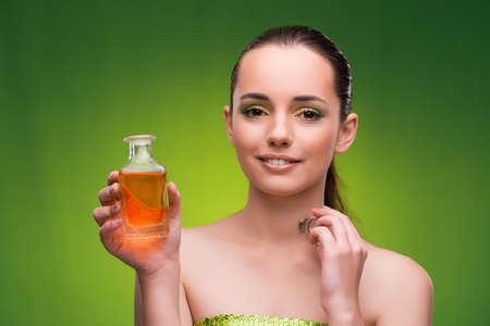 Young woman with bottle of perfume