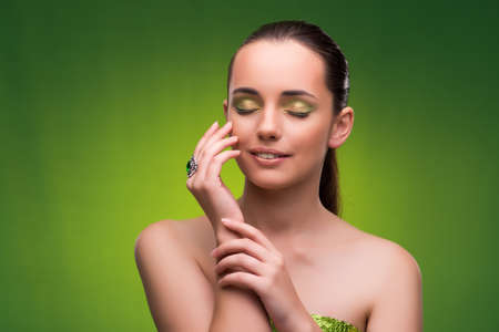 Young woman in beauty concept on green backgroundの写真素材