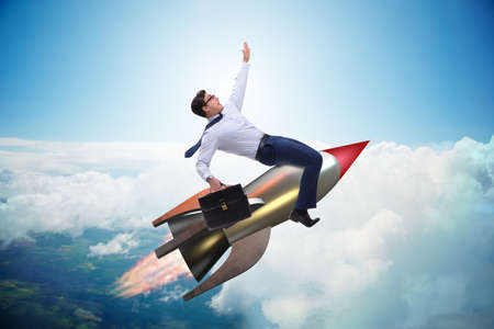 Businessman flying on rocket in business concept