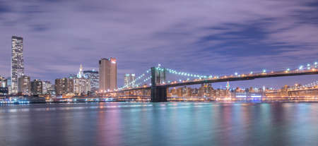 Night view of Manhattan and Brooklyn bridgeの写真素材
