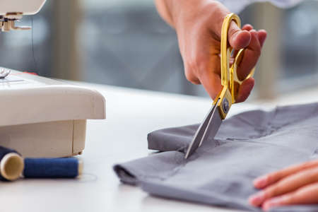 Young man tailor working on new clothingの写真素材