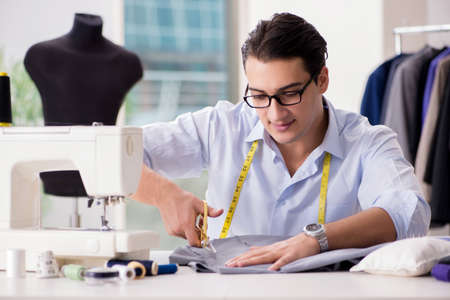Young man tailor working on new clothing