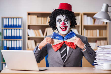 Clown businessman working in the officeの写真素材
