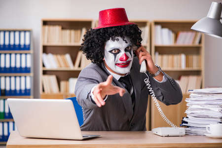 Clown businessman working in the officeの写真素材