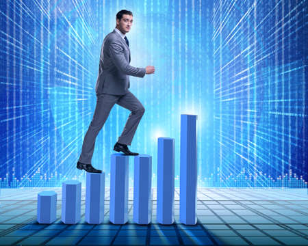 Businessman climbing bar charts in business conceptの写真素材