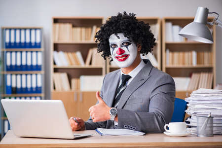 Clown businessman working in the officeの写真素材
