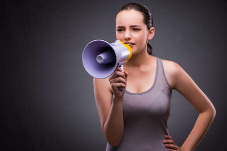 Woman in sports concept with loudspeakerの写真素材