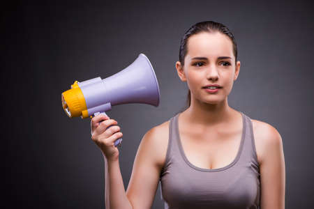 Woman in sports concept with loudspeakerの写真素材