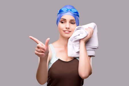 Woman swimmer against grey backgroundの写真素材