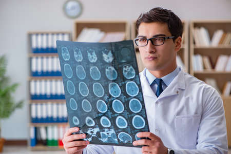 Young doctor looking at computed tomography x-ray image