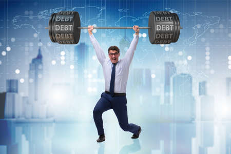 Businessman under heavy burden of debtの写真素材