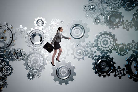 Woman businesswoman walking in cogwheelsの写真素材