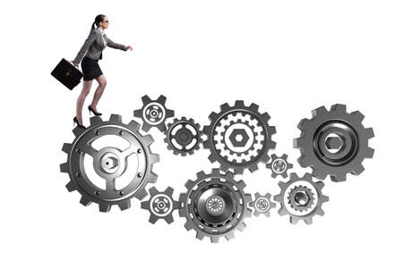 Woman businesswoman walking in cogwheels isolated on whiteの写真素材