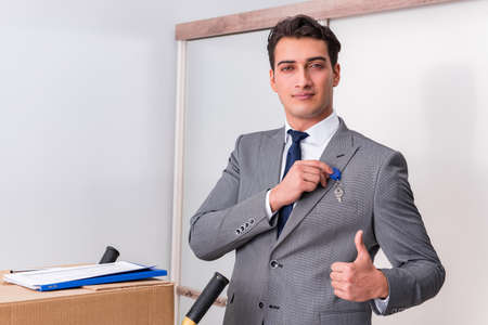 Businessman in real estate concept with home keyの写真素材