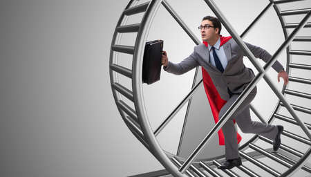 Businessman running on hamster wheelの写真素材