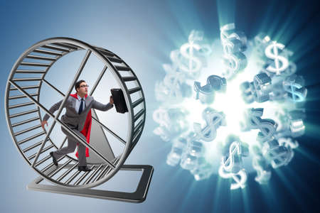 Business concept with businessman running on hamster wheelの写真素材