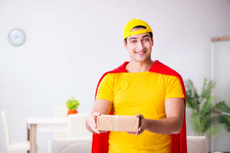 Superhero delivery guy with boxの写真素材
