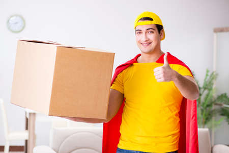 Superhero delivery guy with boxの写真素材
