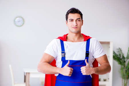Superhero repairman with tools in repair conceptの写真素材