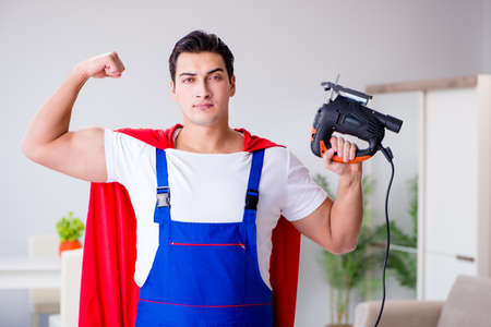 Superhero repairman with tools in repair conceptの写真素材