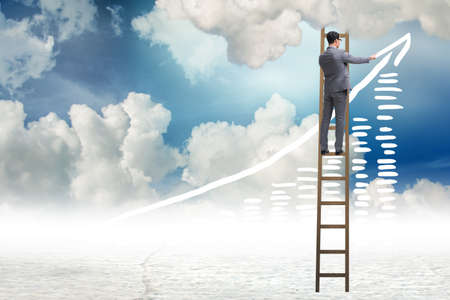 Businessman drawing charts in the skyの写真素材