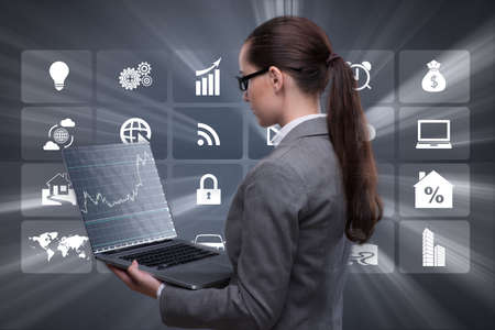 Businesswoman with laptop in business conceptの写真素材