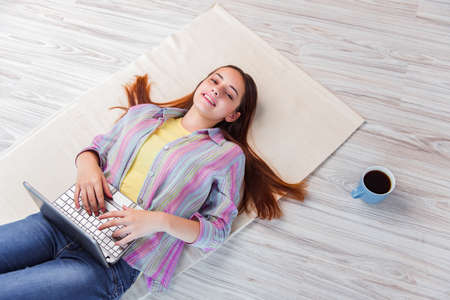 Young girl surfing internet on laptopの写真素材