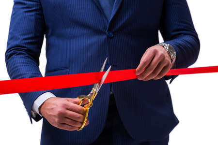 Businessman cutting red ribbon isolated on whiteの写真素材